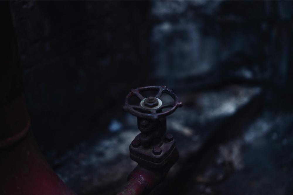 close-up of a valve on a pipe in the dark