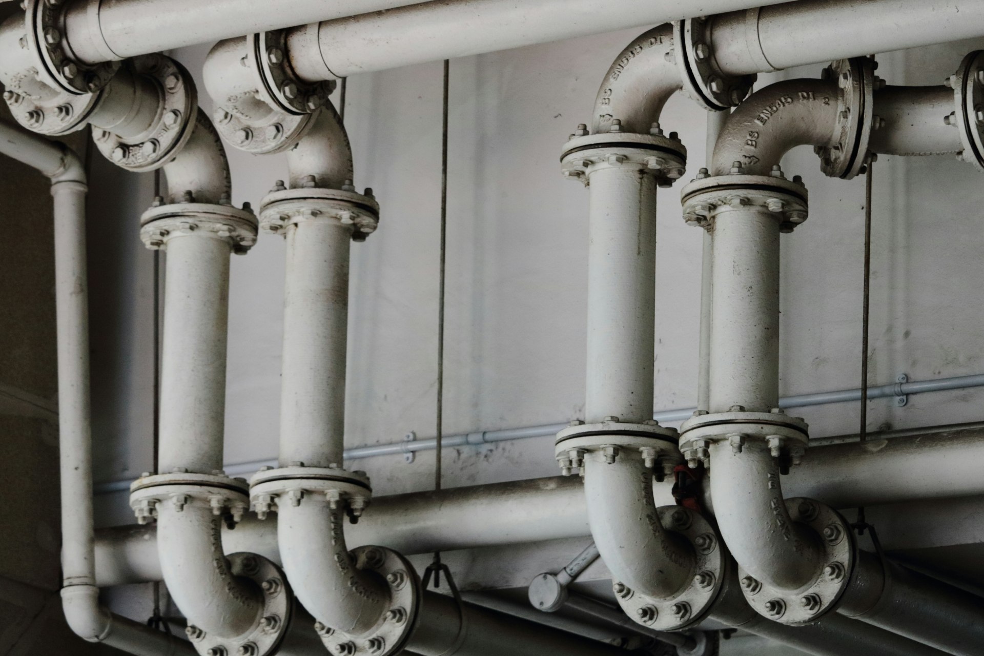 Row of white pipes with valves